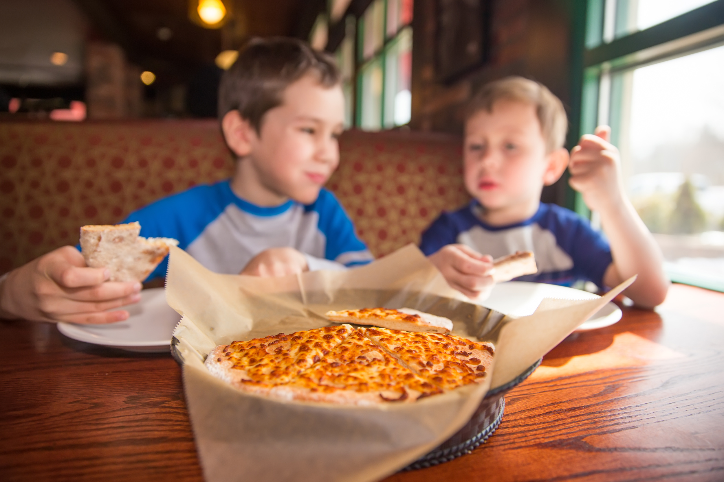 Two children eating pizza